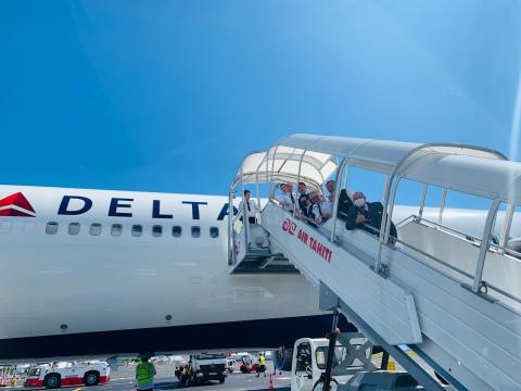 a group of people boarding an airplane