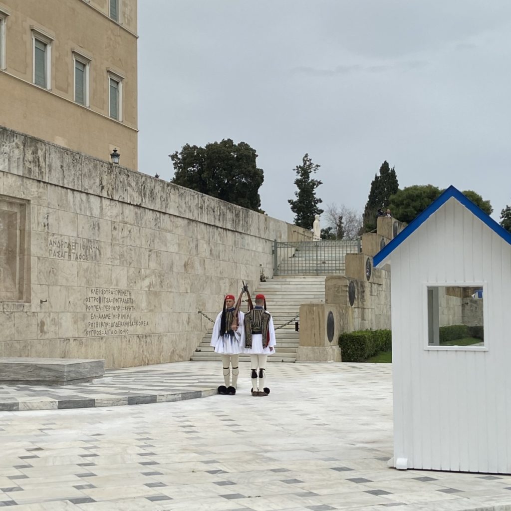 two people in uniforms standing in front of a building