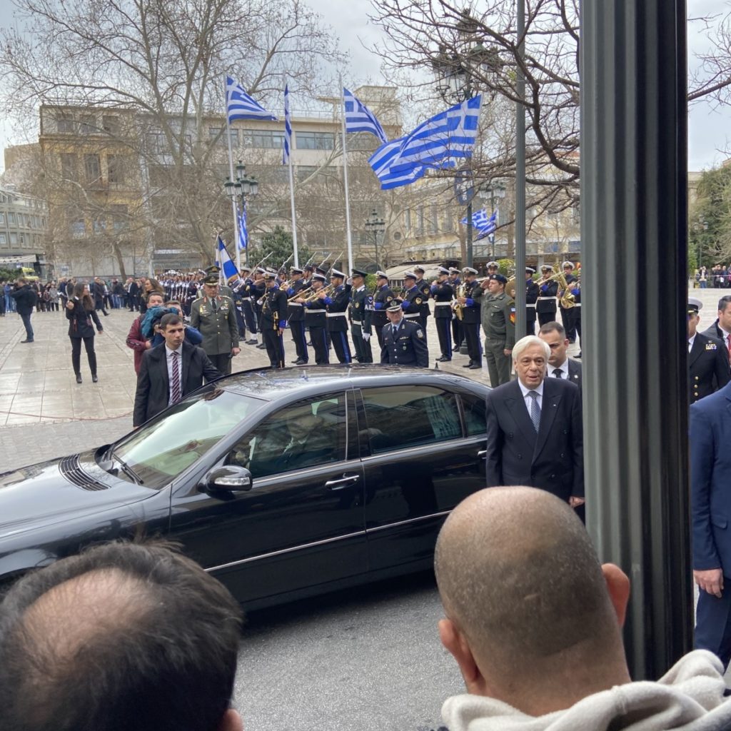 a group of people standing in front of a car