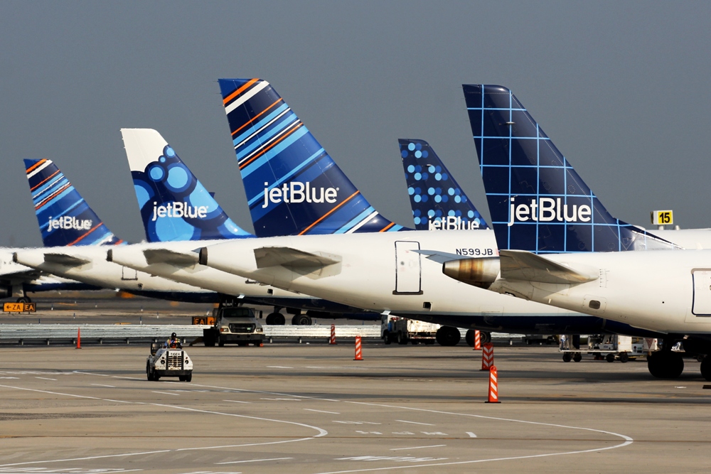 a group of airplanes parked on a runway