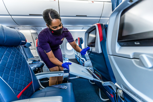 Flight attendant cleaning on board (Source: Delta)