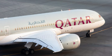 a large white airplane with red writing on it