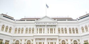 a white building with a flag on top