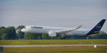 a white airplane on a runway