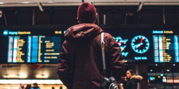 Person looking at departing/arriving flights announcements (Source: Unsplash / Erik Odiin)