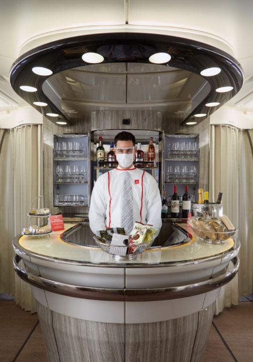 a man wearing a face mask behind a counter