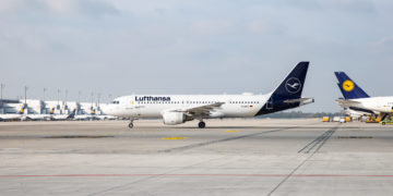 a white airplane on a runway