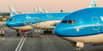 a group of blue airplanes on a runway