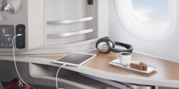 a table with a tablet and headphones on it