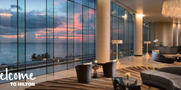 a room with a large window overlooking the ocean