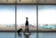 a woman walking with luggage in an airport