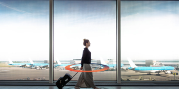 a woman walking with luggage in an airport