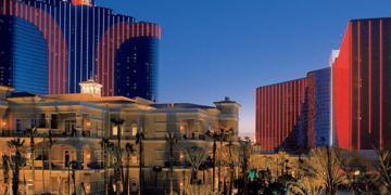 a group of buildings with palm trees with Rio All Suite Hotel and Casino in the background