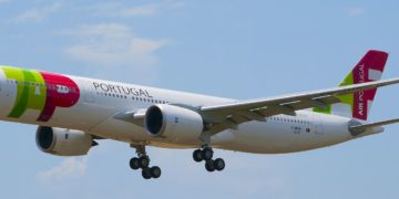 a white airplane flying in the sky