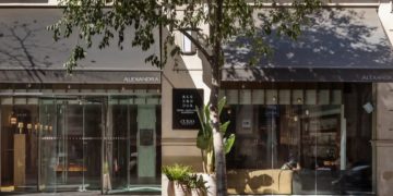 a building with a tree and a sign