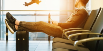 a man sitting in an airport lounge