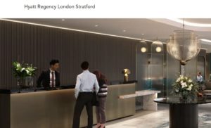 a man and woman standing in front of a reception desk