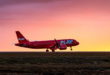 a red airplane on a runway