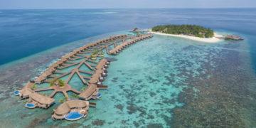 a group of huts on a beach