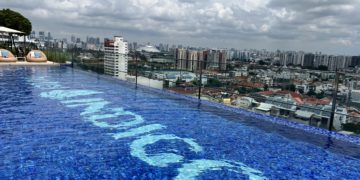 a pool with a city in the background