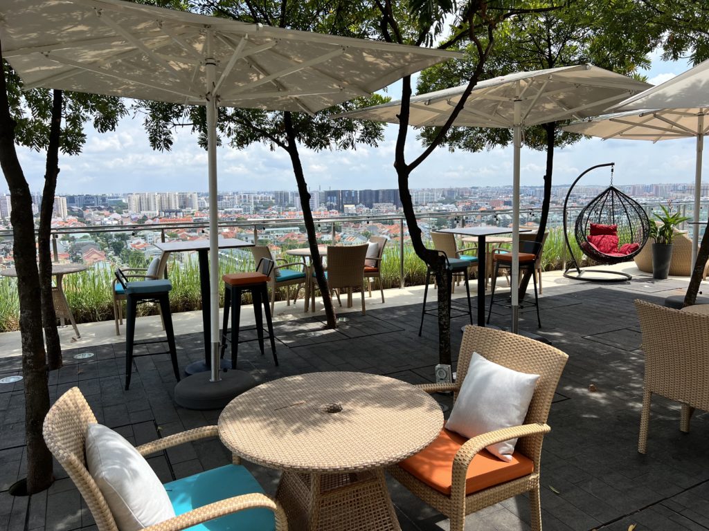 a patio with chairs and umbrellas