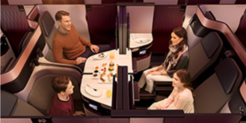 a family sitting at a table in a plane