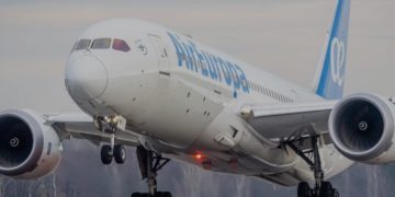 a white airplane with blue writing