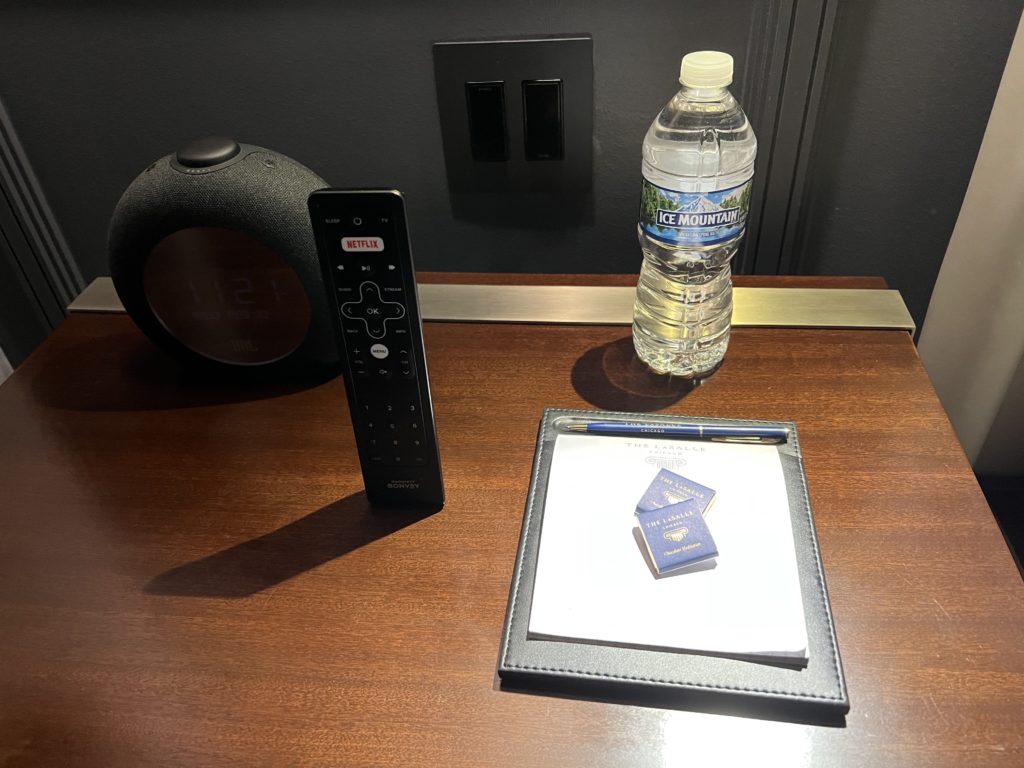 a remote control and a clipboard on a table