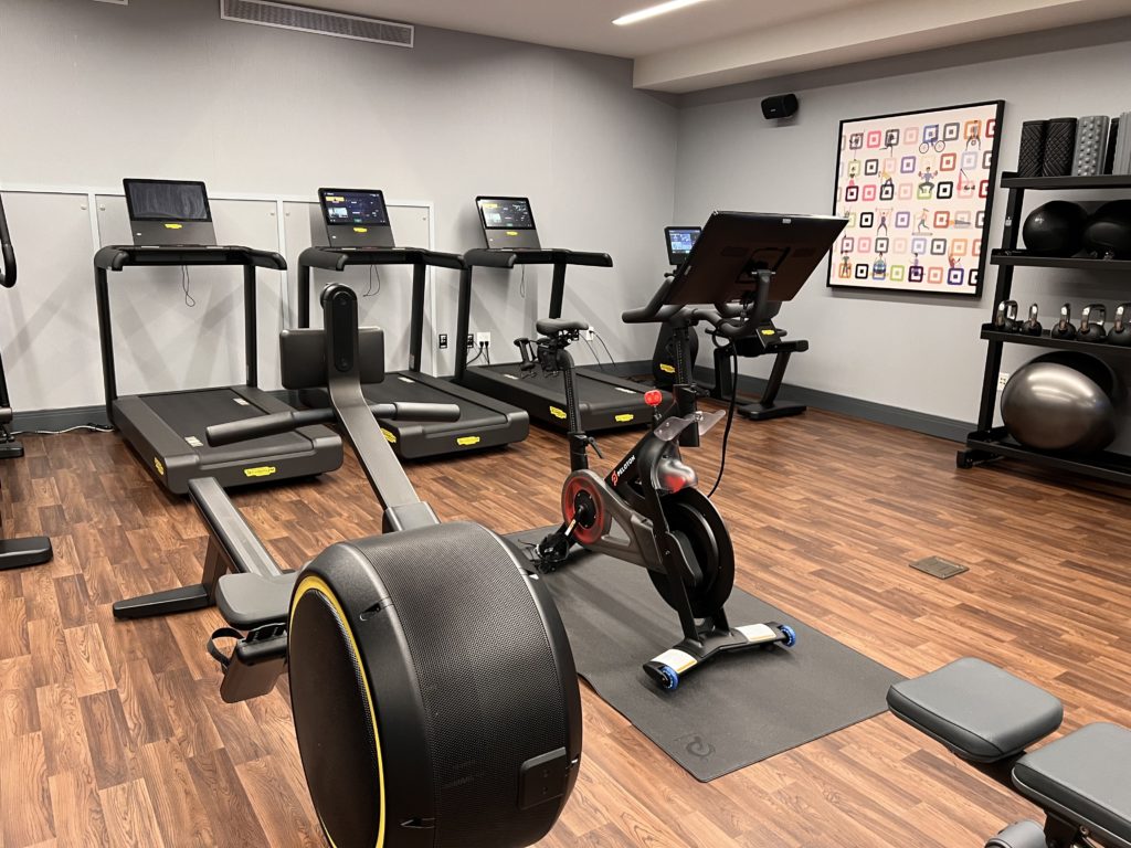 a room with exercise machines and exercise bikes