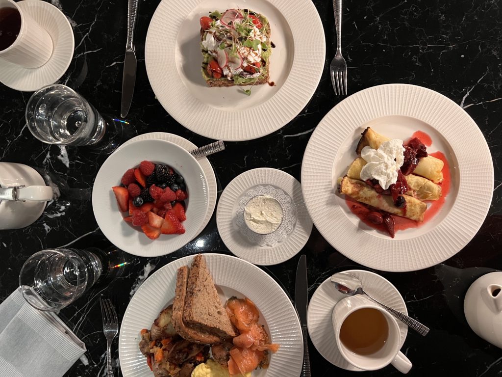 a table with plates of food and utensils