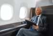 a man in a suit and tie holding a tablet