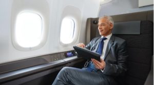 a man in a suit and tie holding a tablet