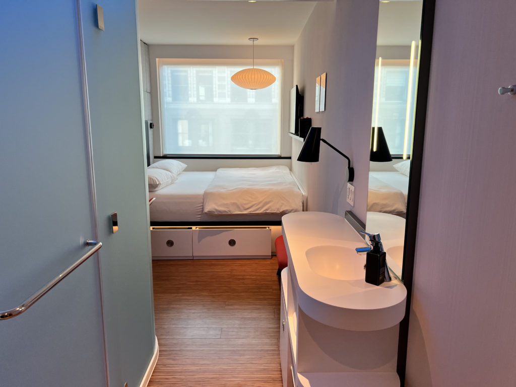 a bathroom with a mirror and a bed