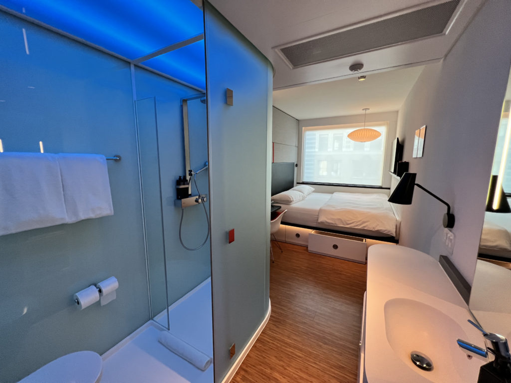 a bathroom with a bed and a shower