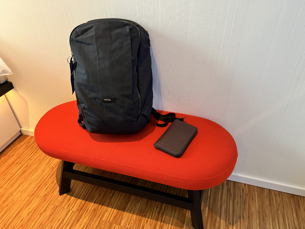 a black backpack on a red bench