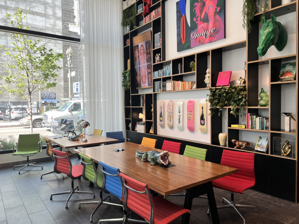 a room with a table and colorful chairs