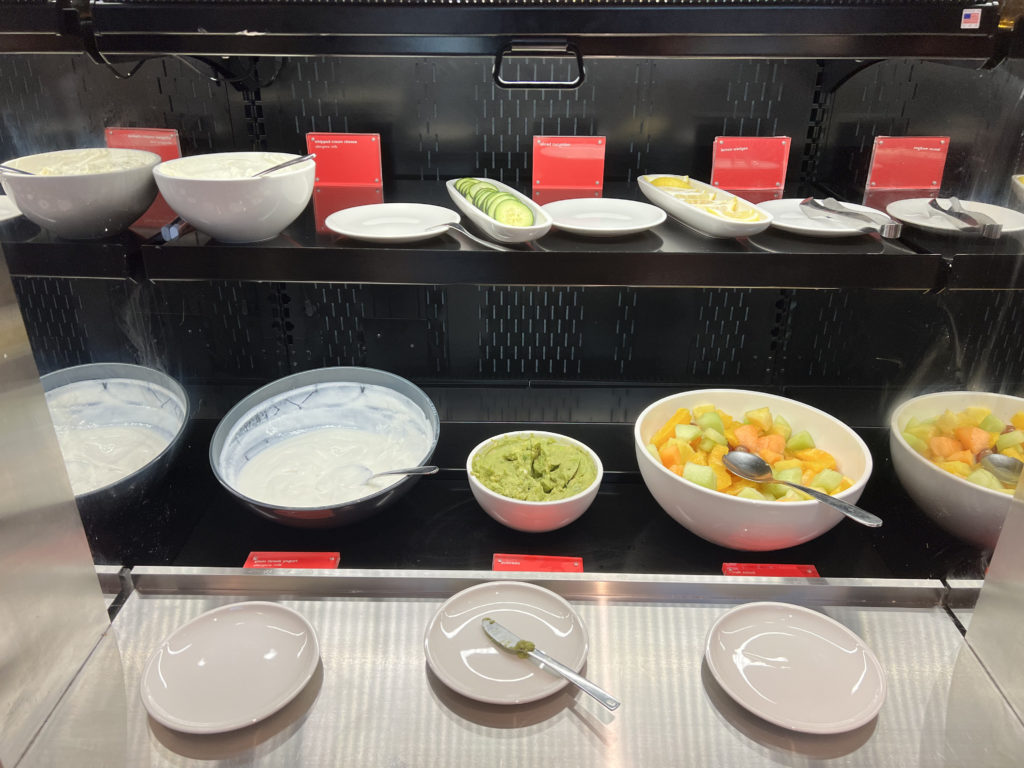 a shelf with bowls of food and plates