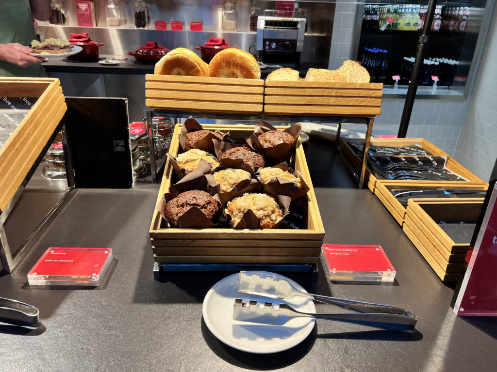 a tray of muffins and bagels on a table