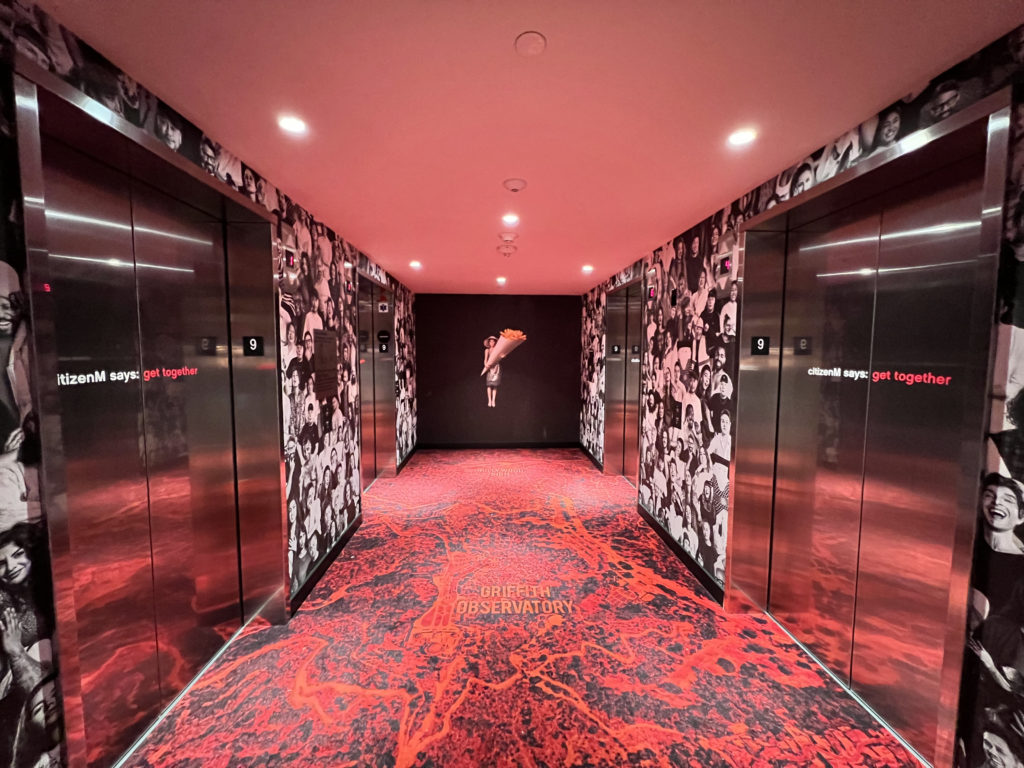 a hallway with elevator doors and red carpet