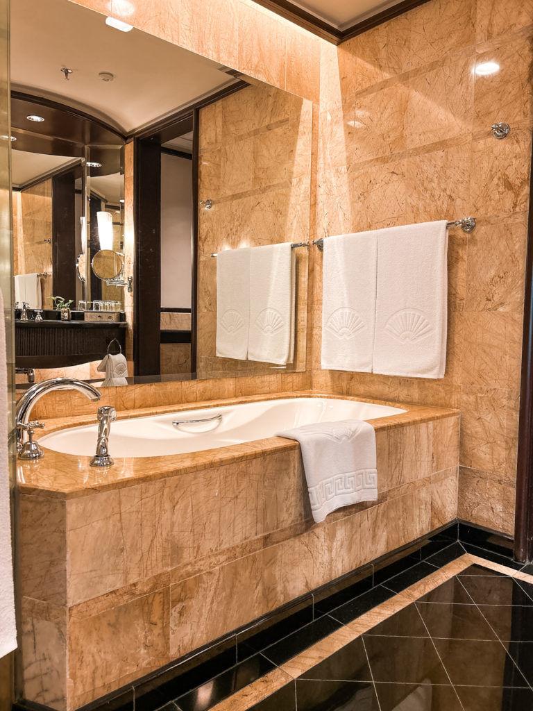 a bathroom with a bathtub and towels