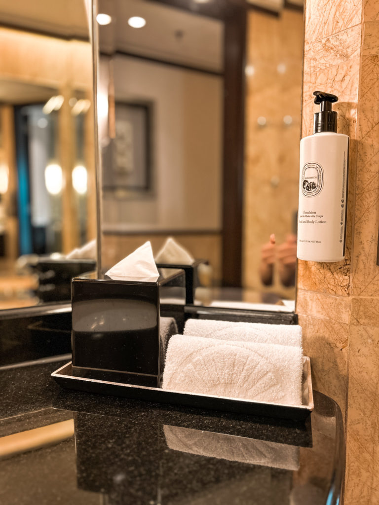 a bathroom sink with a soap dispenser and a tissue box