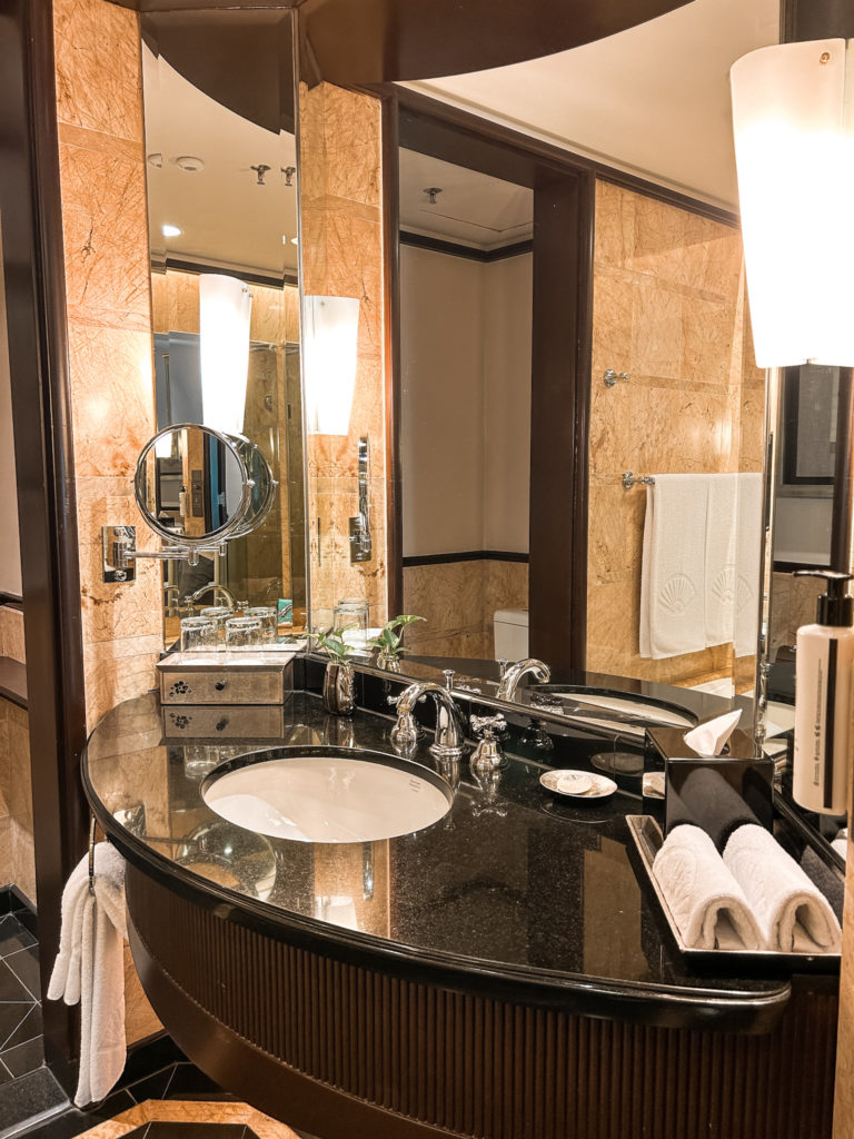 a bathroom with a large mirror and a marble countertop