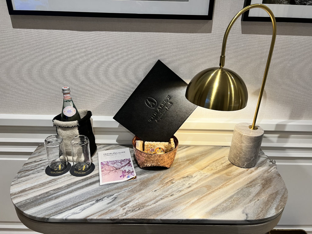 a table with a lamp and a basket of crackers