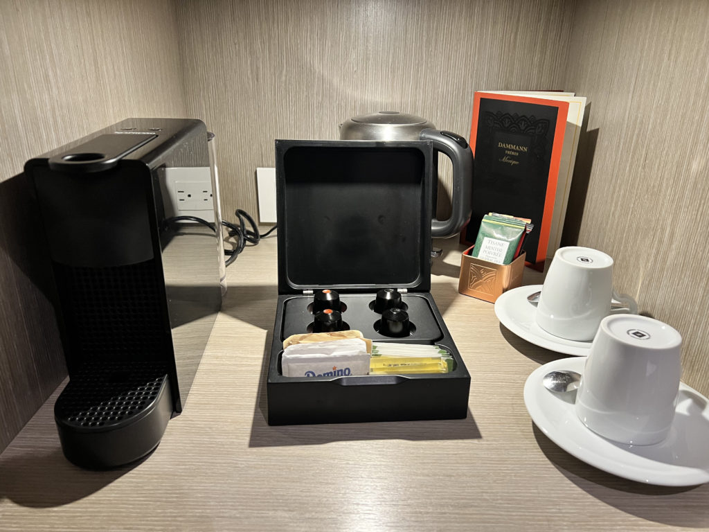 a coffee machine and a small box with a few objects on a table