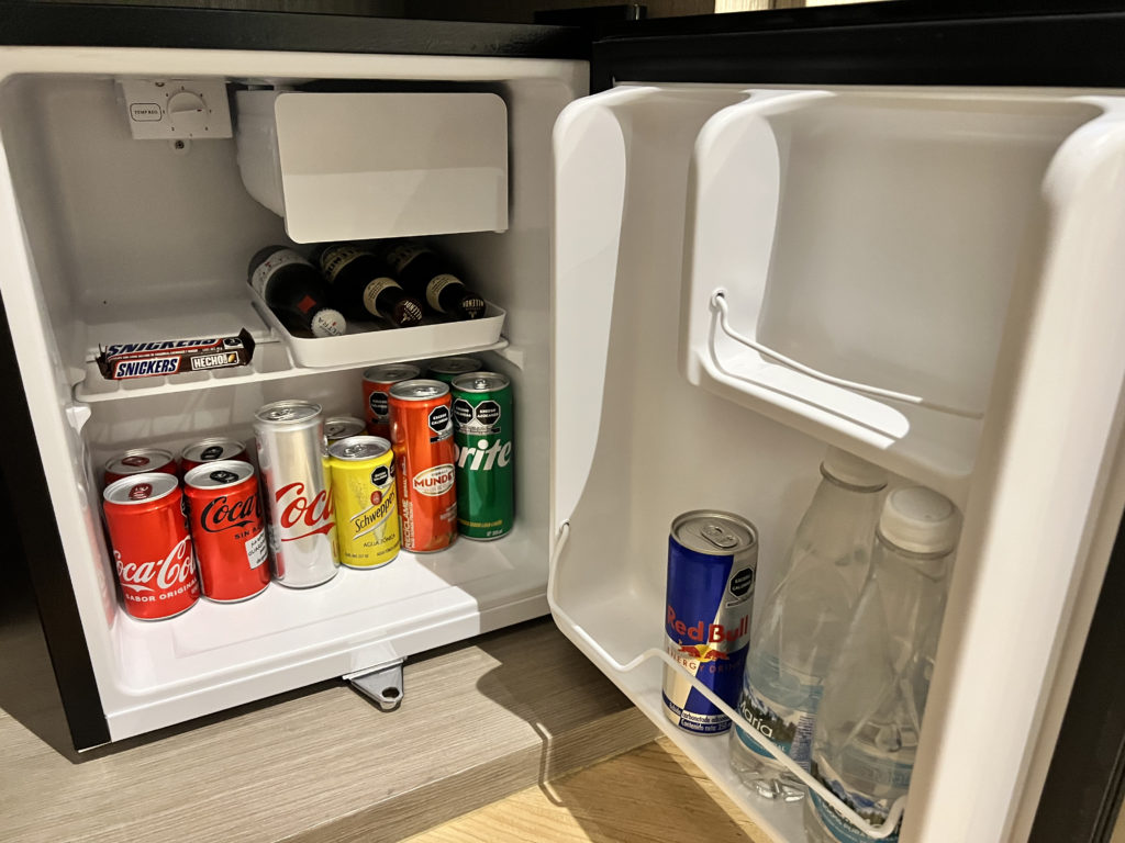 a mini fridge with drinks and cans