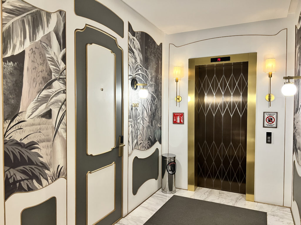 a elevator with doors and a wallpaper