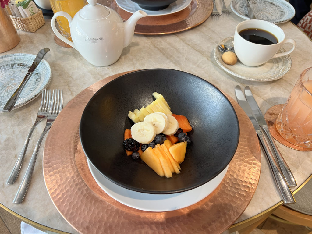 a bowl of fruit and berries on a table