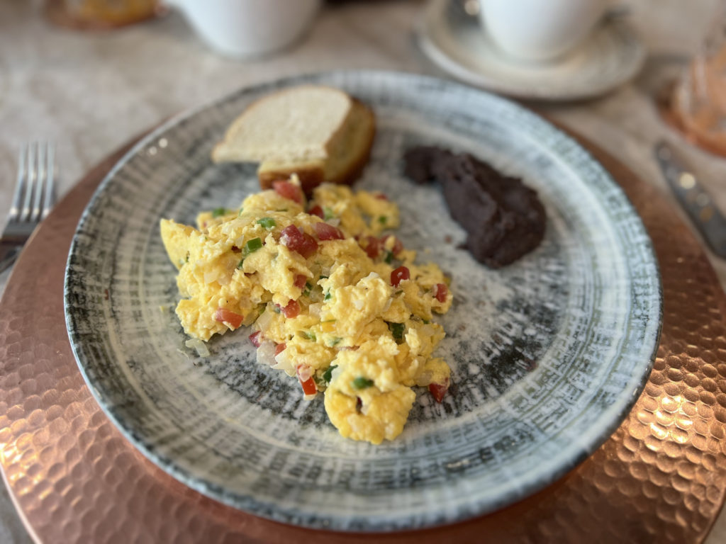 a plate of scrambled eggs and bread