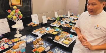 a man standing in front of a table full of food