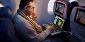 Man using free Wi-Fi on Delta airplane